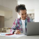 Distance learning online on quarantine. Happy afro girl is studying remote in zoom.