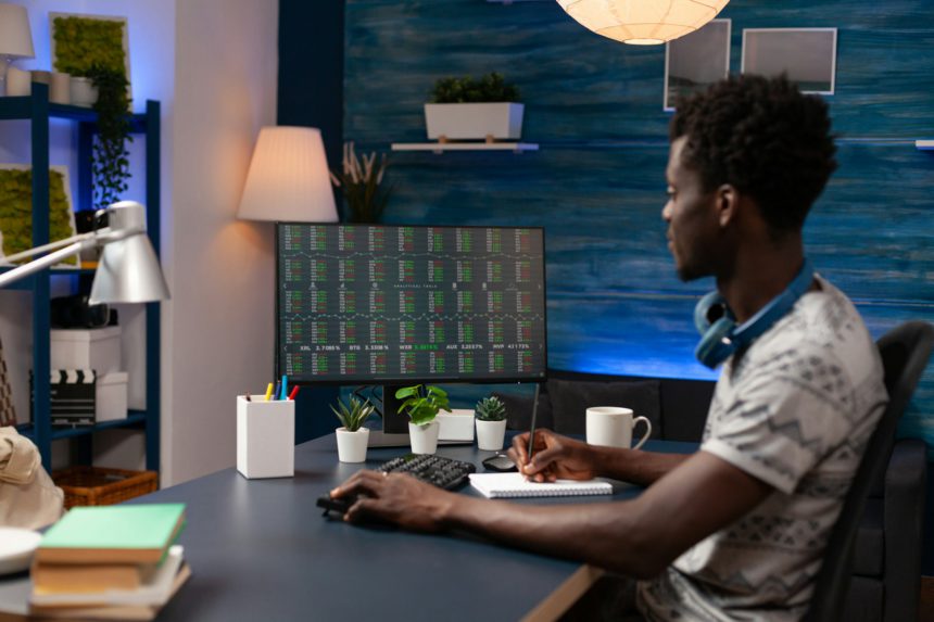 Entrepreneur man sitting at desk table analyzing global economy investment