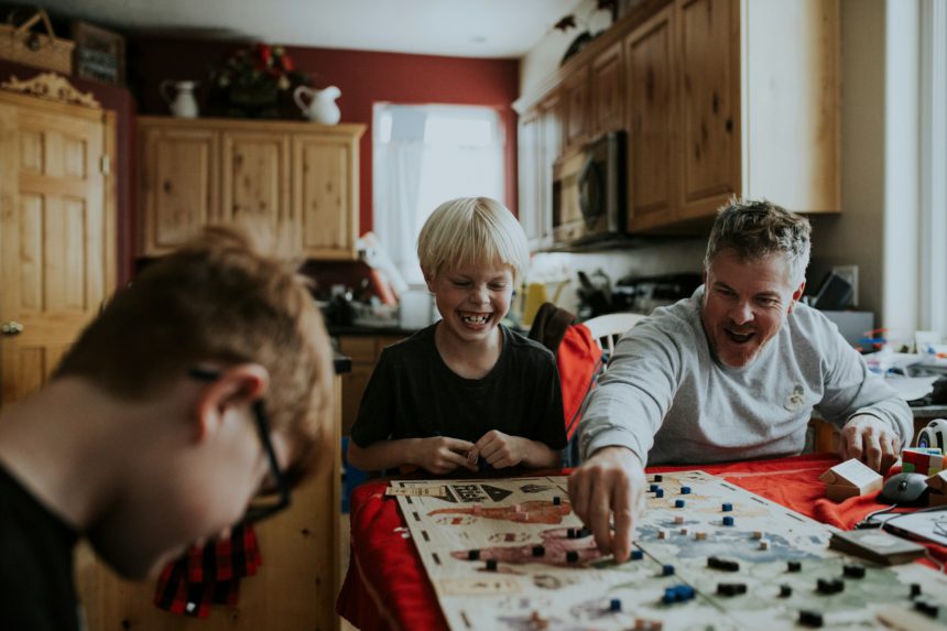 family playing board game together