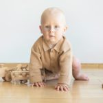 Toddler play with a wooden toys at home. Montessori educational game