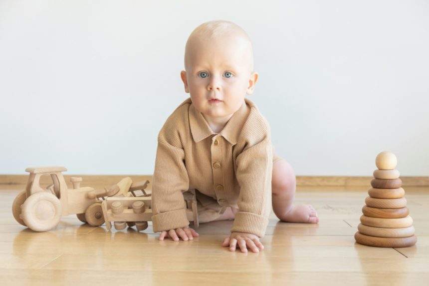 Toddler play with a wooden toys at home. Montessori educational game