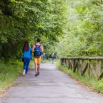 Unrecognizable mixed race mid couple ecotourism hiking in senda del oso, Asturias conservation