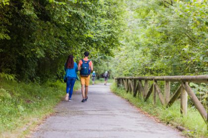 Unrecognizable mixed race mid couple ecotourism hiking in senda del oso, Asturias conservation