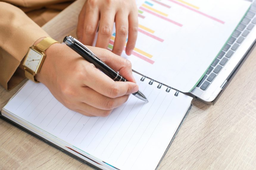 Woman Writing on Organizer